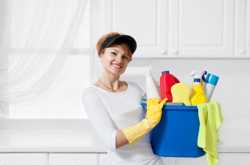 Cleaners Putney staff following safe cleaning procedures