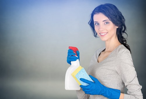 Local cleaner preparing kitchen surfaces during domestic cleaning in Putney